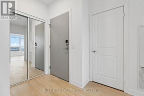 Vaughan (Brownridge) condo for rent - A white door with a black handle is in a room with white walls.