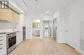 Vaughan (Brownridge) condo for rent - A spacious kitchen with wooden floors and white walls.