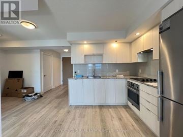 Toronto (Agincourt South-Malvern West) condo for rent - A kitchen with white cabinets and a stainless steel refrigerator.