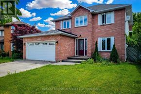 Lincoln (Beamsville) apartment for rent - A red brick house with a white garage door and a red door.