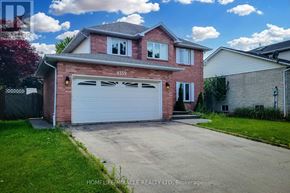 Lincoln (Beamsville) apartment for rent - A red brick house with a white garage door and the number 4559 on the front.