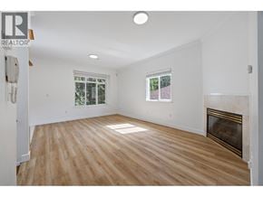 Vancouver apartment for rent - A large, empty room with wooden floors and a fireplace.