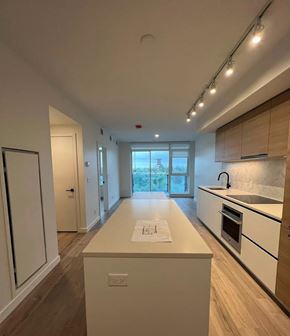 Surrey apartment for rent - A modern kitchen with a long island in the middle.