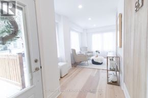 New Tecumseth (Tottenham) apartment for rent - A bright, white room with a wooden floor and a large window.