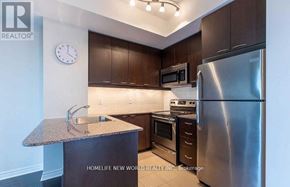 Mississauga (City Centre) condo for rent - A kitchen with a granite countertop and stainless steel appliances.