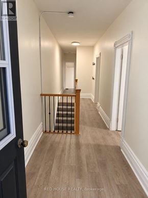 Guelph (Exhibition Park) fourplex for rent - A hallway with a staircase and white walls.