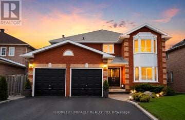 Mississauga (East Credit) apartment for rent - A large brick house with two garage doors is for sale.