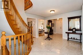 Mississauga (East Credit) apartment for rent - A spacious home interior with a wooden staircase and a round table.