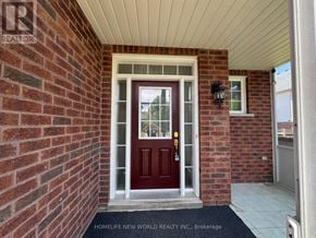 Oshawa (Pinecrest) apartment for rent - A red door with a glass window is the main focus of the image.