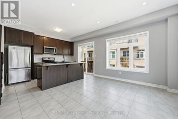 Hamilton (Waterdown) townhouse for rent - A modern kitchen with a refrigerator, microwave, and stove top oven.