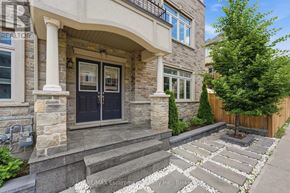 Hamilton (Waterdown) townhouse for rent - A house with a stone facade and a black door.