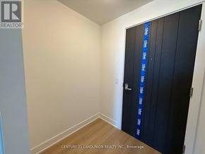 Oshawa (Windfields) condo for rent - A room with a door and a wall with a logo that says REALTOR.