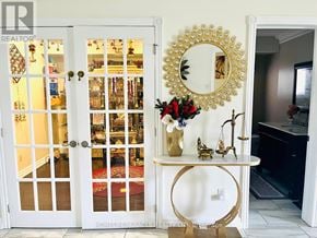 Mississauga (Meadowvale) apartment for rent - A white door with a mirror above it and a table below it.