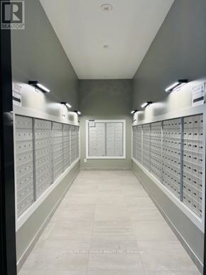 Markham (Greensborough) condo for rent - A hallway with a row of mailboxes on each side.