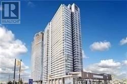 Toronto (Bayview Village) condo for rent - A tall building with a blue sky and clouds in the background.
