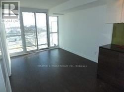 Toronto (Bayview Village) condo for rent - A room with a large window and a wooden floor.