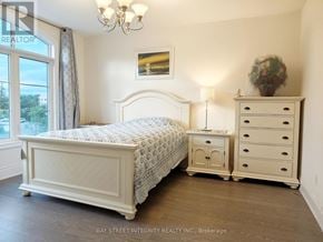 Richmond Hill (Observatory) apartment for rent - A bedroom with a large bed, a nightstand, and a dresser.