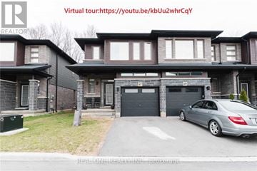 Hamilton (Meadowlands) townhouse for rent - A modern house with a grey car parked in front.