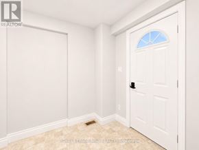 Port Colborne (Killaly East) apartment for rent - A white door with a window in the middle is in a room with white walls.