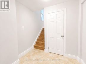 Port Colborne (Killaly East) apartment for rent - A white door is in a hallway with a light switch on the wall.