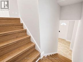 Port Colborne (Killaly East) apartment for rent - A staircase with wooden steps and white walls.