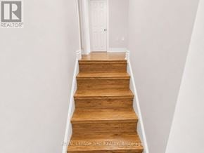Port Colborne (Killaly East) apartment for rent - A set of wooden stairs leading to a white door.