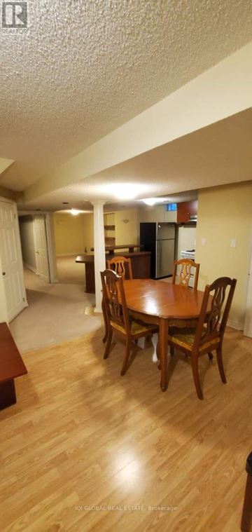 Mississauga (Fairview) apartment for rent - A dining room with a wooden table and chairs.