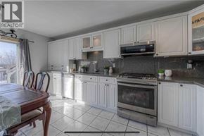 Cambridge apartment for rent - A kitchen with white cabinets and a wooden table.