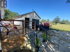 Prince Edward County (Hillier) apartment for rent - A house with a wooden deck and a red chair.