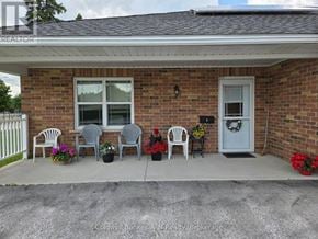 Wellington North (Mount Forest) townhouse for rent - A house with a grey door and a wreath on it.