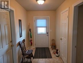 Wellington North (Mount Forest) townhouse for rent - A hallway with a chair and a door.