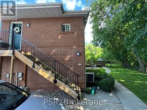 Toronto (Leaside) apartment for rent - A brick house with a black gate and a car parked in front.