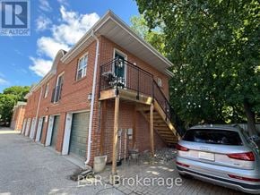 Toronto (Leaside) apartment for rent - A silver Audi is parked in front of a red brick house.