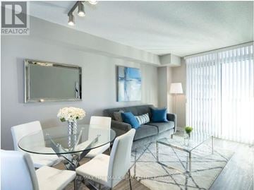 Toronto (Church-Yonge Corridor) condo for rent - A modern living room with a glass table and white chairs.
