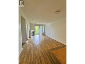 Vancouver apartment for rent - A room with wooden flooring and a window with blinds.
