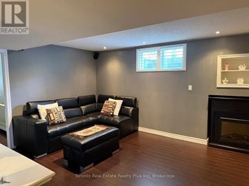 Brampton (Bram East) apartment for rent - A living room with a black leather couch and ottoman.