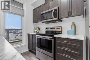 Beamsville townhouse for rent - A modern kitchen with a stainless steel oven and microwave.