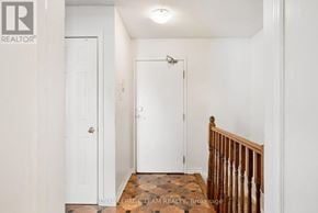 Ottawa townhouse for rent - A white door with a gold handle is in a white room.