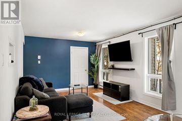 Ottawa townhouse for rent - A living room with a black couch and a wooden coffee table.