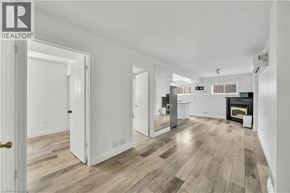 Kitchener apartment for rent - A spacious living room with a fireplace and hardwood floors.