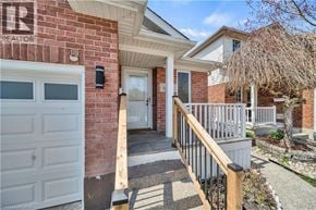 Kitchener apartment for rent - A house with a red brick exterior and a white garage door.
