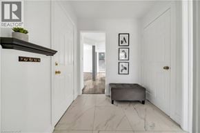 Kitchener apartment for rent - A hallway with a bench and pictures on the wall.