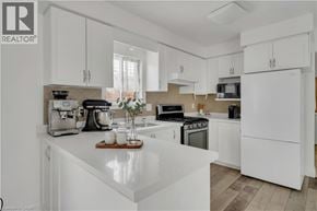 Kitchener apartment for rent - A white kitchen with a wooden tray on the counter.
