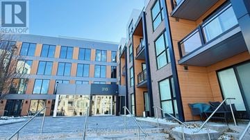 Oakville (Go Glenorchy) condo for rent - A modern building with the number 210 on it.
