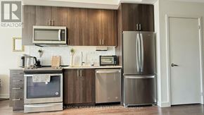 Oakville (Go Glenorchy) condo for rent - A kitchen with a refrigerator, oven, and microwave.