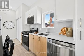 North York apartment for rent - A kitchen with a stove top oven and microwave.