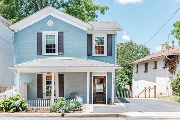 Charlottesville apartment for rent - A blue house with a white porch and a white fence.