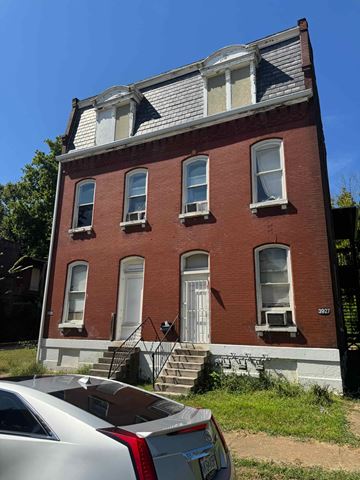 Saint Louis apartment for rent - A red brick building with a white door and windows.