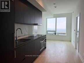 Toronto (Bay Street Corridor) condo for rent - A kitchen with black cabinets and a stove top oven.