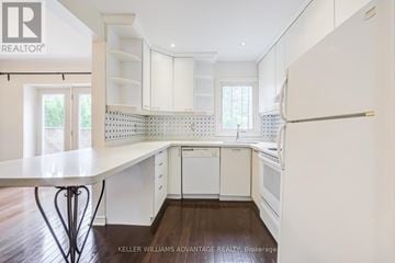 Toronto (Broadview North) apartment for rent - A white kitchen with a table and chairs.